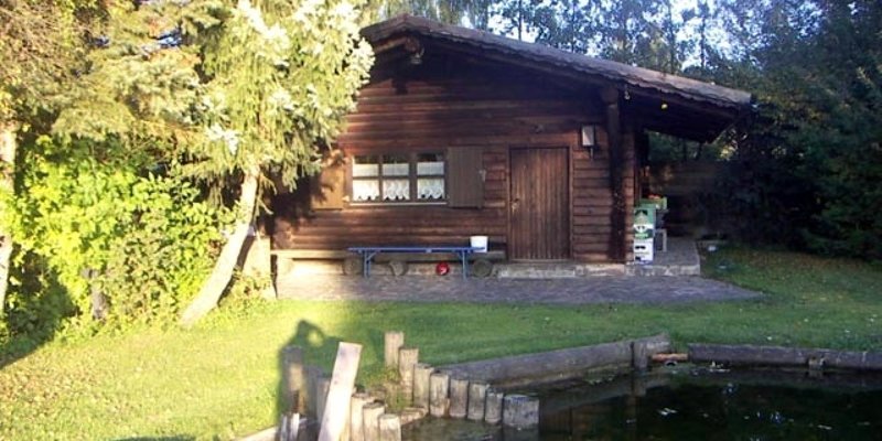 Pond site with log cabin